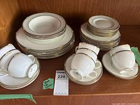 Stacked dinner plates, soup bowls, cups, saucers, small plates