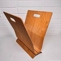 Angled view showing V-shape, handle slot, wood grain