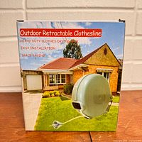 Front of boxed outdoor retractable clothesline