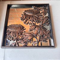 Full view of square mirror with copper floral overlay