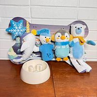 Full lot: five plush toys on bone backing with slow feeder bowl in front
