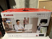 Front view of the Canon Pixma TR4720 printer box with branding and promotional image.