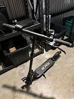 Full view of the Gravity Blade electric scooter from the side, showing handlebar, stem, and platform.