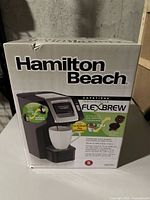 Hamilton Beach FlexBrew coffee machine in original packaging, showing product image and box branding.