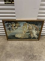 Full view of framed Birth of Venus artwork on a floor against a wall
