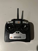 Front view of the Spektrum DX4e RC controller showing dual joysticks, antenna, power switch and branding.