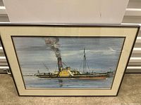 Framed painting or print showing a steam boat on water with smoke coming from the funnel.