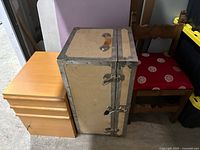 Photo showing vintage wooden chest, small dresser, and wooden chair from an angle.