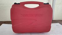 Front of red Rotozip carrying case