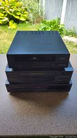 Front view of three stacked VHS VCRs