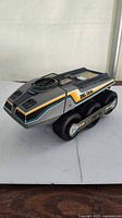 Left front side view of Big Trak showing body graphics and tracks