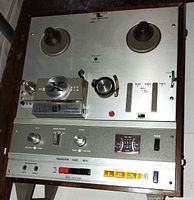 Front view showing reel hubs, control panel, meters and cartridge section