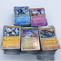 Front view of five stacked bundles of Japanese Pokémon cards