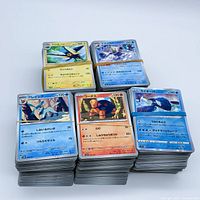 Five stacks of Japanese Pokémon cards bound with rubber bands