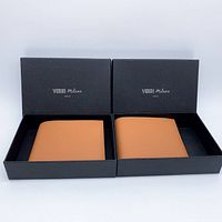 Two tan Verri Milano wallets in black branded boxes