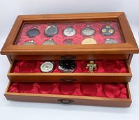 overall view of wooden case showing top glass lid and two drawers with watches inside