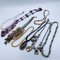 Group shot of all eight necklaces laid out