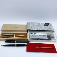 All items laid out showing boxed and loose pens