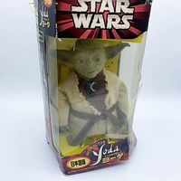 Front view of boxed Interactive Yoda showing figure and Star Wars branding