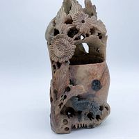 Full view of carved soapstone vase showing overall form and motifs