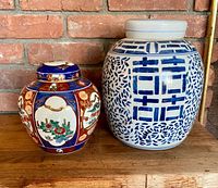 Both ginger jars side by side showing size comparison and designs