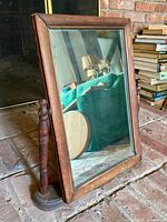 Front view showing dark wood frame and mirror surface