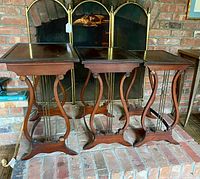 Front view of all three nesting tables in front of fireplace