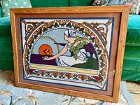 Front view of framed needlepoint tapestry showing full design and frame