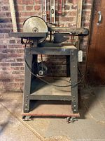 Front view showing belt, disc, frame, motor, base