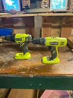 Front view of both Ryobi drill drivers on workbench