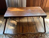 Top view of wooden coffee table showing plank construction and surface wear