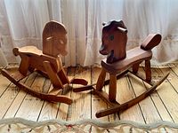 Both wooden rocking horses side by side