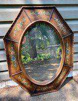 Full view of octagonal mirror with floral frame
