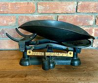 Full view of balance scale showing scoop pan, flat pan, base