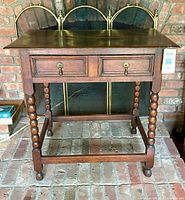 Full view of wooden accent table showing top, legs, drawer, stretcher