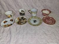Group shot of four teacups and four saucers showing assorted patterns