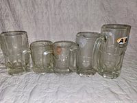 Front view of five assorted A&W mugs