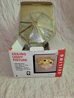 Retail box showing octagonal brass flush mount light fixture and specifications