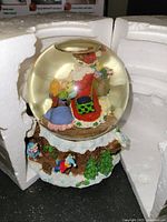 Resin snow globe featuring Santa and children