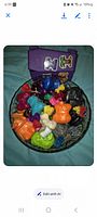 Top view of bowl containing multicolored Crazy Bones figures
