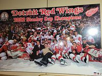 Full view of the Detroit Red Wings 2002 Stanley Cup Champions commemorative poster showing the entire team photo on ice celebrating the win, with text and logos visible.