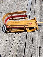Top angled view of entire sled showing heart logo and pull handle