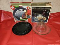 Both boxed items with grill plate, cheese dome and platter displayed