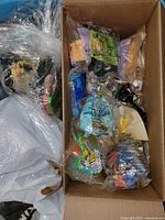 Cardboard box containing multiple individually bagged Happy Meal toys