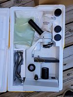 Microscope with power cord and accessories in molded foam packaging