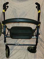 Full front view of rollator showing frame, wheels, seat, backrest
