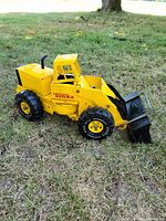 Left side view showing full truck, bucket lowered