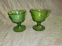 Front view of creamer and sugar bowl showing color, pattern and pedestal bases