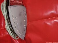 Soleplate of vintage Vornado iron showing surface rust, dirt, and scratches.