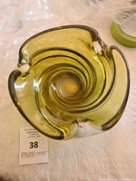 Top view of the crystal ashtray showing swirl pattern and light olive green color.